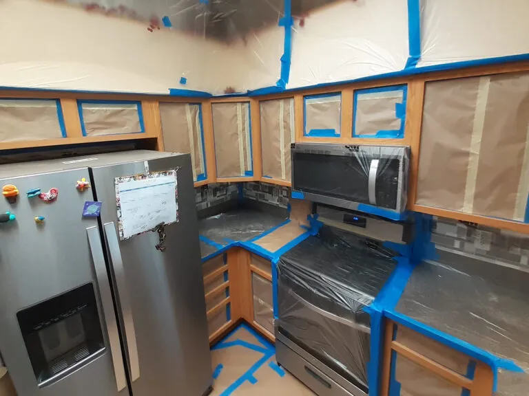 Luxury kitchen painting Ottawa - navy blue cabinets, gold handles, marble countertop design
